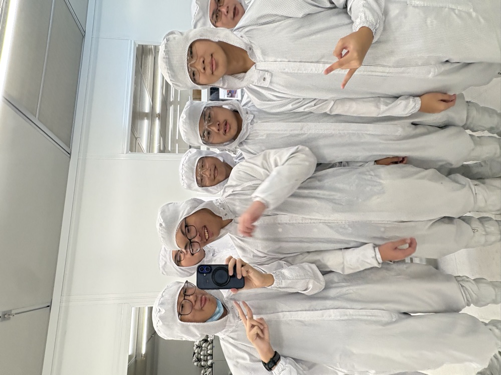 In cleanroom suits on the semiconductor fab tour